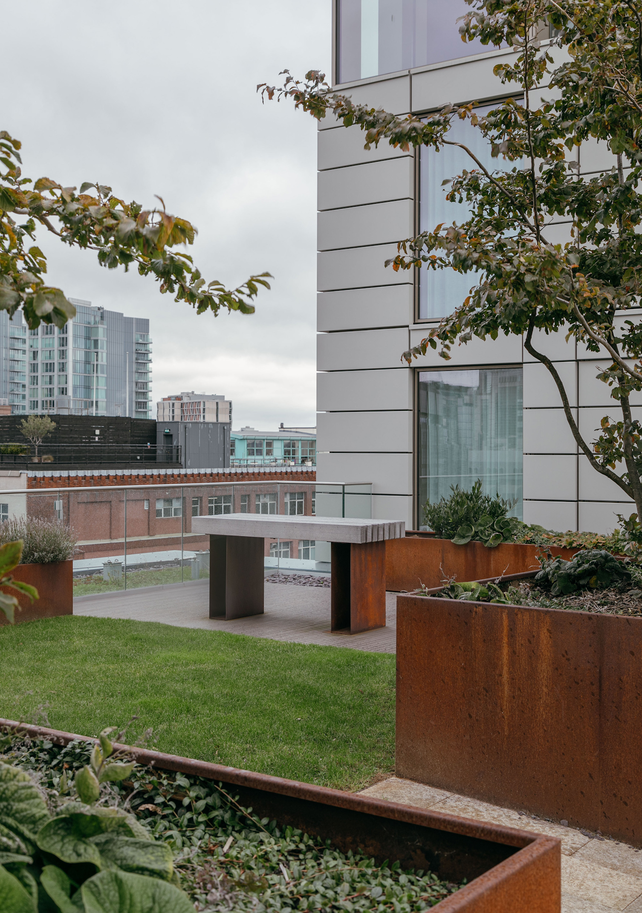 Corten steel planters and timber bench at Royal Mint Gardens