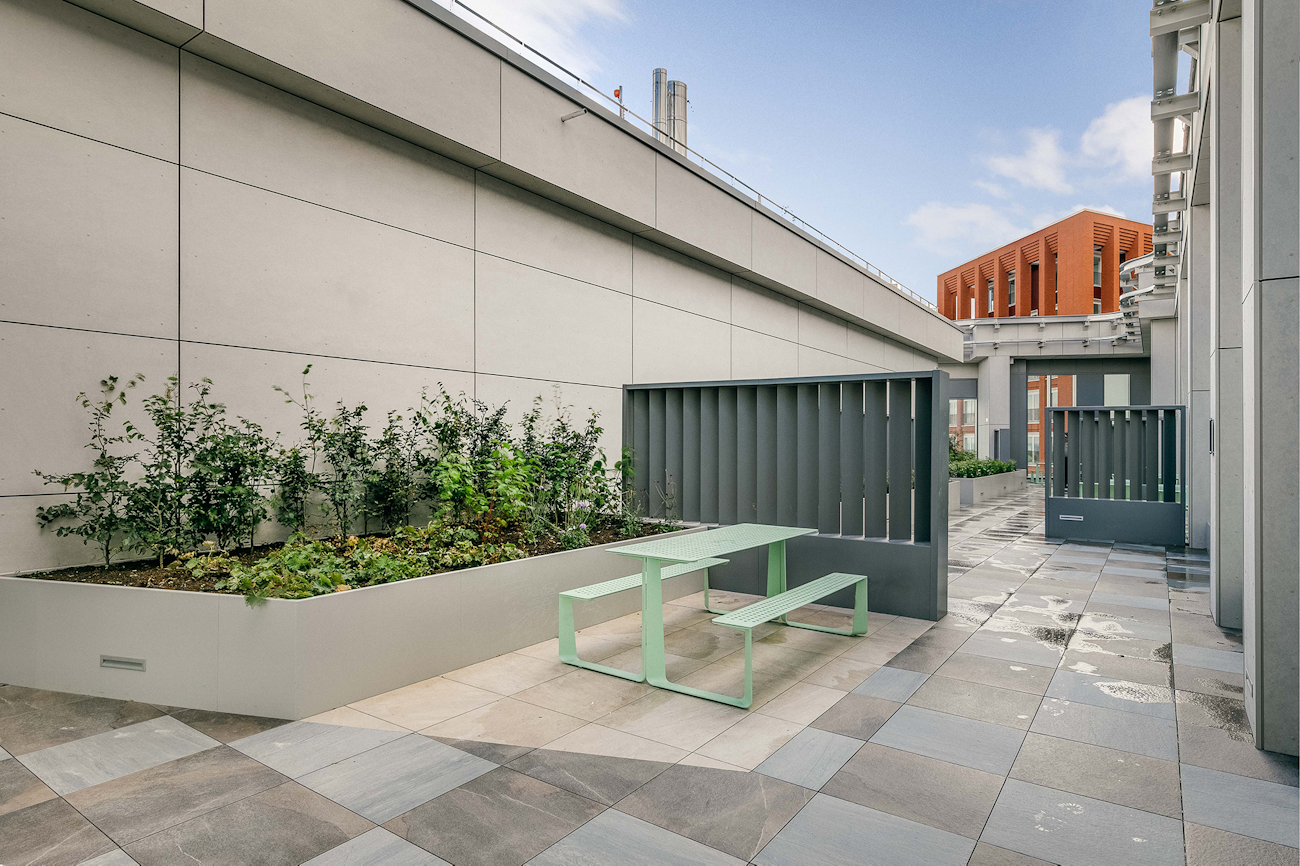 Porcelain tiles and powder-coated stell planters at Vega, Miles Street